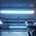 A photograph of a well-lit garage ceiling featuring modern led lights
