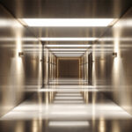 A photograph of a well-lit egress pathway featuring modern lighting solutions