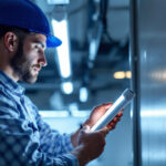 A photograph of capture a photograph of a lighting contractor installing philips f32t8 fluorescent tubes in a commercial setting