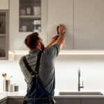 A photograph of a well-lit kitchen featuring stylish strip under counter lighting