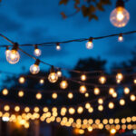 A photograph of a beautifully illuminated outdoor space featuring string lights
