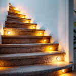 A photograph of a beautifully illuminated staircase featuring modern step light bulbs