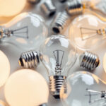 A photograph of a close-up of various standard light bulb bases arranged aesthetically