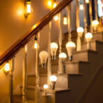 A photograph of a well-lit staircase featuring various types of energy-efficient light bulbs