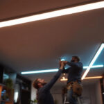 A photograph of a well-lit interior space showcasing ceiling led light strips in action