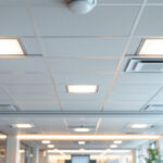 A photograph of a well-lit drop ceiling installation in an office space
