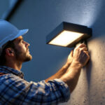 A photograph of a professional lighting contractor installing a sleek