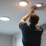 A photograph of a modern interior space featuring recessed ceiling can lights in action