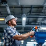 A photograph of a lighting contractor installing t12 to led bulbs in a commercial setting