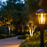 A photograph of a stylish heavy-duty outdoor lamp post illuminated at dusk