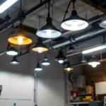 A photograph of a well-lit garage showcasing various modern light fixtures installed