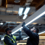 A photograph of a well-lit installation of a fluorescent ho light fixture in a commercial setting