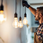 A photograph of a lighting contractor installing energy-efficient led fixtures in a modern space