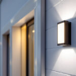 A photograph of a well-lit outdoor setting featuring the sunco lighting outdoor led wall pack installed on a building