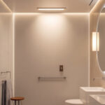 A photograph of a well-lit bathroom featuring a sleek recessed shower light installation