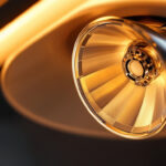 A photograph of a close-up shot of a reflector bulb with a twist and lock connector installed in a stylish light fixture