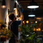 A photograph of a skilled lighting contractor expertly installing modern lighting fixtures in a stylishly illuminated space