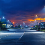 A photograph of a well-lit outdoor commercial site at dusk