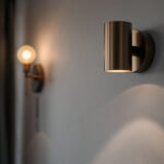 A photograph of a beautifully designed sconce wall light installed in a stylish interior setting