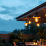 A photograph of a beautifully designed outdoor ceiling lamp illuminated in a serene evening setting