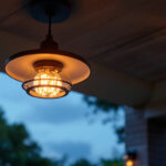 A photograph of a beautifully designed outdoor ceiling fixture illuminated at dusk