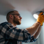 A photograph of capture a photograph of a lighting contractor installing recessed lighting clips in a ceiling