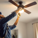 A photograph of a lighting contractor in action