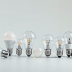 A photograph of a variety of light bulb bases displayed together on a clean