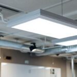 A photograph of a well-lit installation of 2 x 4 flat panel led lights in a modern commercial space
