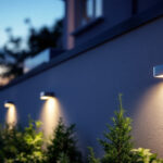 A photograph of a beautifully illuminated exterior wall showcasing solar-powered wall lights in a residential or commercial setting
