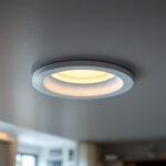 A photograph of a beautifully designed recessed light cover installed in a modern ceiling