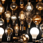 A photograph of a diverse array of light bulbs from different eras
