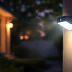 A photograph of a well-lit outdoor setting showcasing a motion sensor security light in action