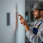 A photograph of a lighting contractor expertly installing a smart 4-way switch in a modern home setting