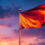 A photograph of a flagpole illuminated by solar lights at dusk