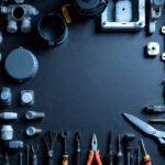 A photograph of a well-organized workbench featuring various types of junction boxes and covers
