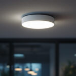 A photograph of a ceiling motion sensor installed in a modern commercial space