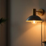 A photograph of a stylish wall light fixture plugged in