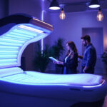 A photograph of a modern tanning bed in a well-lit salon setting