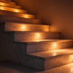 A photograph of a beautifully illuminated staircase featuring stylish stair puck lights