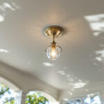 A photograph of a beautifully designed outdoor cathedral ceiling with an elegant ceiling mount light fixture