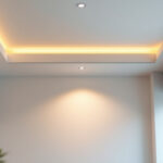 A photograph of a well-lit room featuring stylish recessed can lights installed in a modern ceiling
