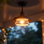A photograph of a stylish ceiling porch light fixture elegantly illuminated in a cozy outdoor setting