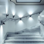 A photograph of a well-lit stairwell that showcases various lighting fixtures