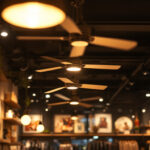 A photograph of a stylishly designed retail shop interior featuring modern ceiling fans that enhance both the lighting and ambiance