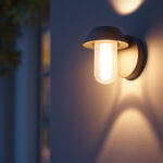 A photograph of a stylish outdoor wall light with an integrated outlet installed on a home exterior