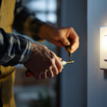 A photograph of a lighting contractor skillfully installing a single pole switch in a residential setting