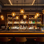 A photograph of a beautifully designed bar area featuring stylish overhead lighting fixtures that highlight the ambiance and aesthetics