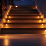 A photograph of a beautifully illuminated side mount stair lighting installation