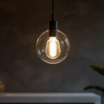 A photograph of a beautifully designed individual hanging light fixture in a stylish interior setting
